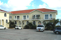 Two of the three buildings that make up Turtle Nest Inn & Condos, with the ocean view building at left, and the beachfront building in the centre.