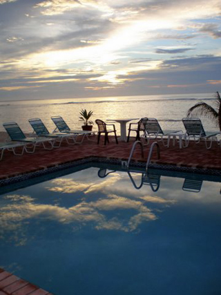 Stunning sunrises and sunsets on Grand Cayman.  Sunset view from one of the pool decks.