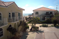 The beachfront condo building (left), the original Inn building, and the Caribbean beyond -- as seen from the second bedroom of an ocean view condo (TNI Photo)