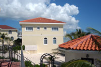 Sideview of the beachfront condo building, with the poolhouse in the foreground (TNI Photo)