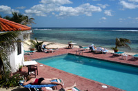 One of the two seaside pools, at Turtle Nest Inn & Condos -- with the Caribbean Sea in the background (TNI Photo)